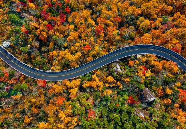 Blue Ridge Parkway scenic overlook with dramatic mountain views and perfect lighting